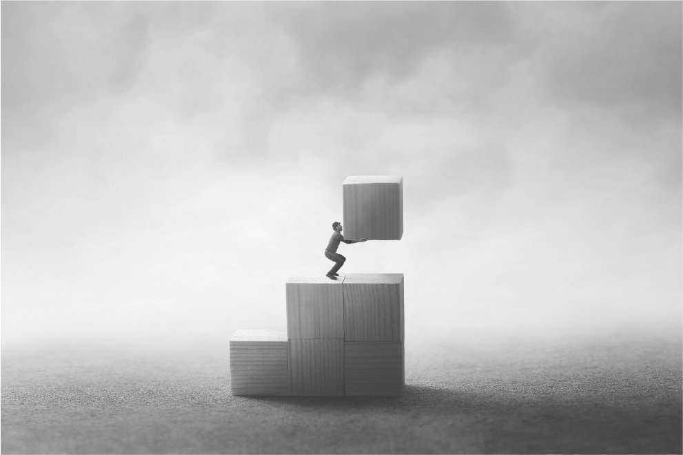Person stacking blocks representing early-stage angel investments